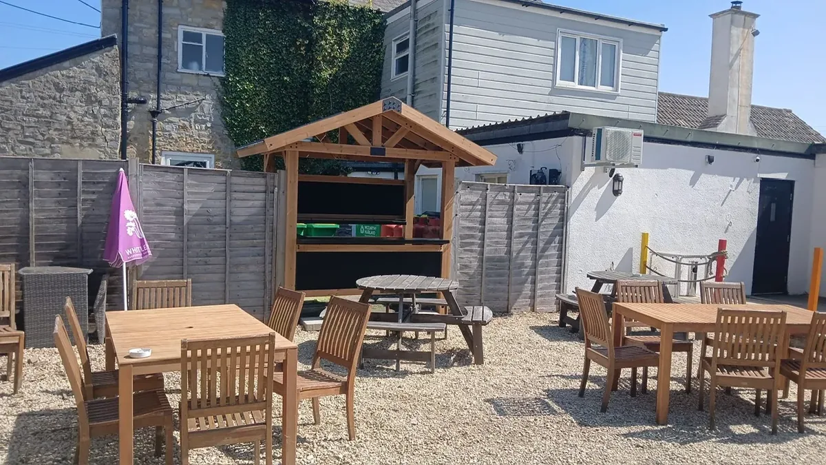 The pub garden set with tables and chairs on a sunny day